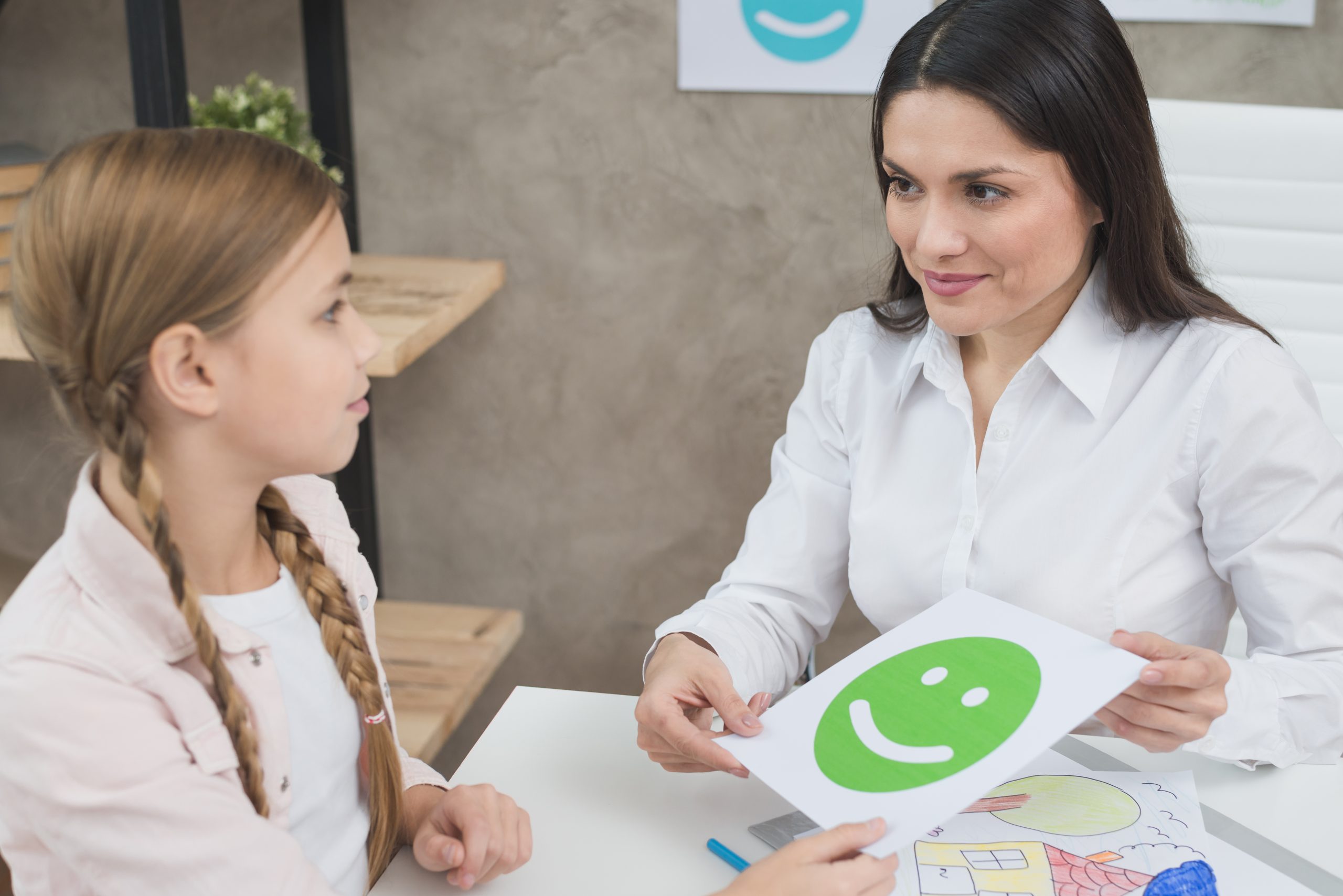 friendly young female psychologist girl holding happy emotion face card scaled